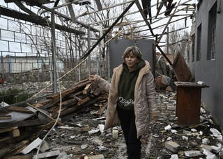 Svitlana Rudokvas shows a destroyed restaurant in the heavily damaged building in the village of Novopavlivka